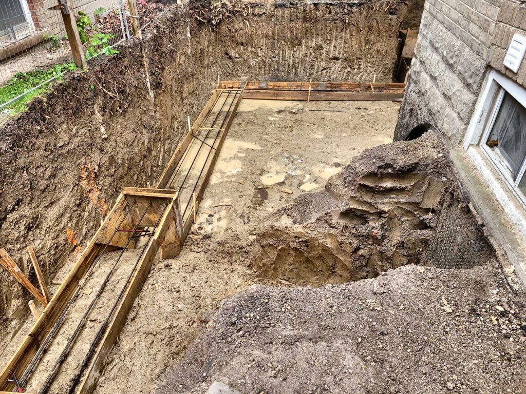Footing trench beside house, concrete footings in Barrie by Grand Structural Services